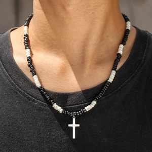 Bohemian black and white wood bead necklace with stainless steel cross pendant on model
