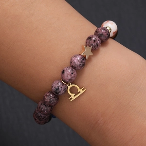 Natural stone bead Libra bracelet with gold star charm worn on a female wrist