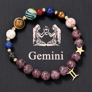 Close-up of Gemini beaded bracelet with natural stones and golden constellation charms