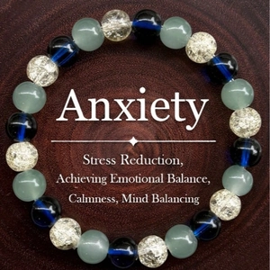 Elegant anxiety relief bracelet with rose quartz and hematite beads on dark wood