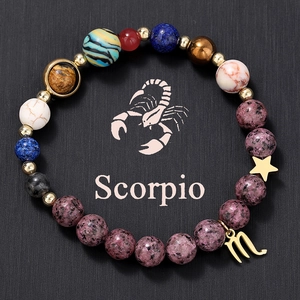 Detailed shot of Scorpio natural stone beaded bracelet with gold celestial charms