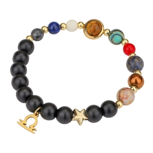 Detail of natural stone beads bracelet with Libra zodiac sign and star gold pendants