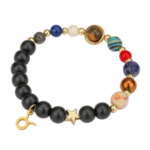 Solar system bracelet detail with natural stones and Taurus zodiac charm on white back