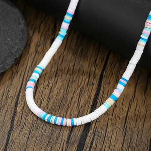Detailed close-up of colorful handmade Heishi clay bead necklace with vibrant summer tones