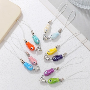 Marine style ceramic fish phone charms with magnetic hearts on a white background