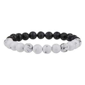 Detail of lava stone and white marble turquoise beaded bracelet with metallic spacers