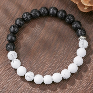 Detail of lava rock and howlite beaded bracelet with an antique silver spacer bead