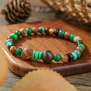 Vintage African turquoise and wood bead bracelet with tribal eye bead on wood tray