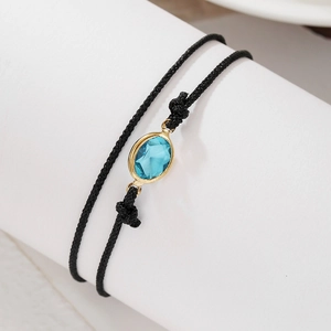 Tobillera minimalista de cordón negro doble con circón azul ovalado y oro