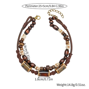 Detailed view of bohemian leather anklet with wood beads, skull charm and size labels