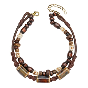 Boho layered leather anklet with wood beads, skull charms, and glazed stone accents