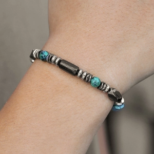 Detail of turquoise beads and faceted black hematite bead on a men's bracelet
