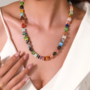 Gros plan détaillé du collier bohème à double épaisseur avec des perles carrées géométriques