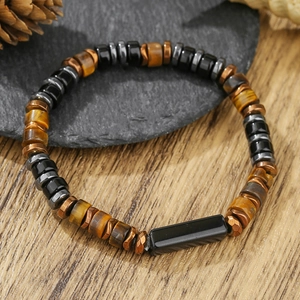 Tiger eye and wooden bead bracelet for men on rustic stone and wood background
