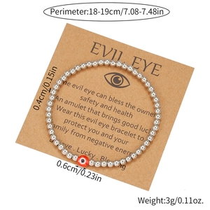 Silver beaded Evil Eye bracelet on display card with 0.4cm beads and red charm accent