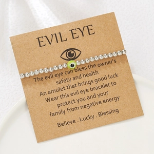 Detail of silver beaded Evil Eye bracelet on a kraft card with inspirational message