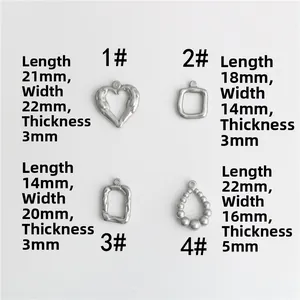 Détail de quatre pendentifs en acier inoxydable de formes géométriques variées