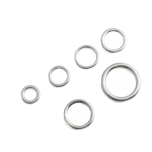 Detailed macro view of five assorted sizes of silver stainless steel seamless O-rings