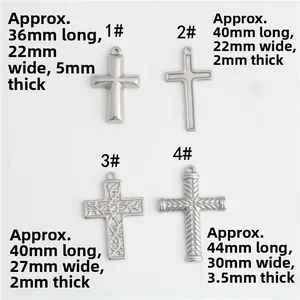 Detailed view of four textured stainless steel cross pendants for DIY jewelry making