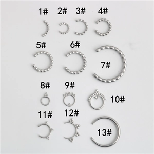 Macro detail of various stainless steel moon-shaped pendants and DIY jewelry components