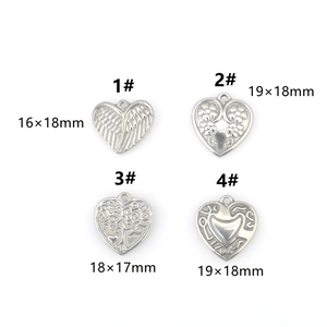 Detailed set of four stainless steel heart pendants with floral and tree of life patterns
