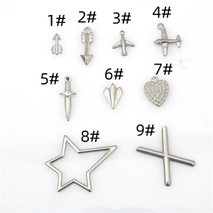 Macro view of stainless steel punk charms including airplane, dagger and heart shapes