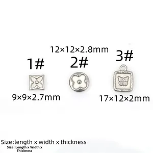 Macro view of assorted stainless steel clover and flower charms for jewelry making