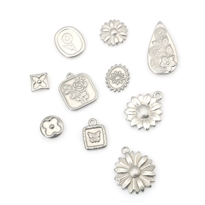 Assorted stainless steel flower pendants including daisies and clovers for DIY jewelry