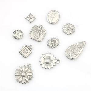 Various silver stainless steel pendant charms featuring daisy, clover, and rose designs