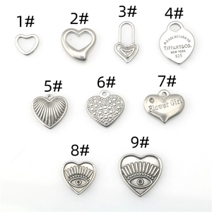 Collection of nine vintage silver heart charms with various engraved and hollow patterns