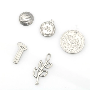 Set of stainless steel DIY charms featuring a wrench, leaf, and engraved coin pendant