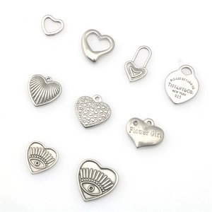 Variety of heart-shaped stainless steel charms with engraved details and textures