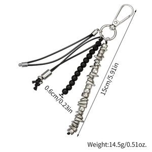Black beaded keychain with irregular metal pieces and lobster clasp on white background