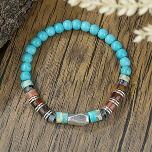 Bohemian turquoise beaded bracelet with silver geometric metal accents on dark wood