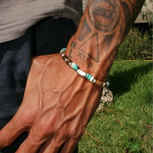 Bohemian turquoise and tiger eye beaded bracelet for men on a natural outdoor background