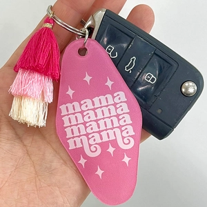 Detail of pink acrylic Mama keychain with colorful layered tassels and silver ring