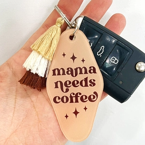 Detail of mama needs coffee acrylic keychain with multi-color tassels and car key fob