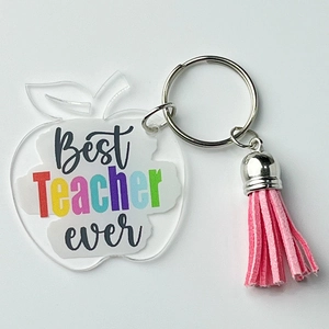 Acrylic apple keychain with pink tassel and Best Teacher Ever text on white background