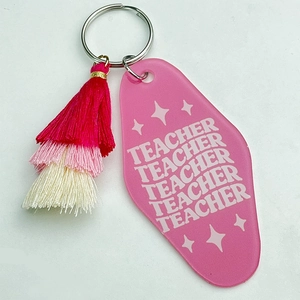 Detail of pink acrylic motel-style teacher keychain with a three-layer gradient tassel