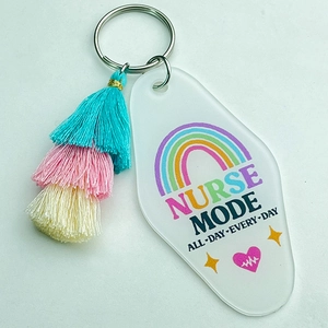 Detail of nurse mode acrylic keychain featuring a three-tier colorful tassel and heart icons