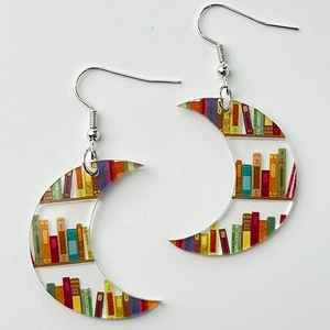 Detail of crescent acrylic earrings featuring library bookshelf patterns and silver hooks