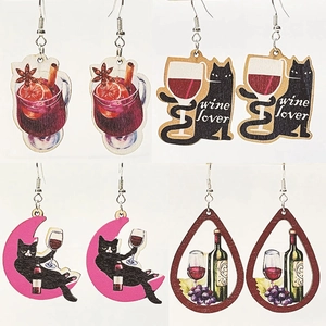 Detailed view of four wooden wine cat earrings featuring black cats and wine lovers themes