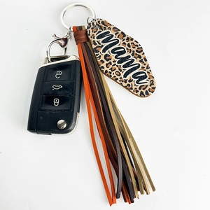 Detail of leopard print Mama keychain with multi-color leather tassels and silver ring