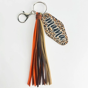 Close-up of leopard print keychain with multi-color leather tassels and mama script detail