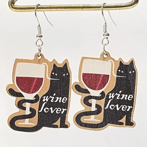 Artistic wooden wine lover earrings with cat motif on a golden bar display