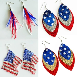 Close-up of patriotic American flag earrings with feathers and glitter leather details