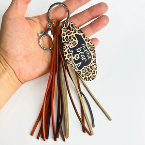 Detailed shot of leopard print mama bear motel tag with colorful leather tassels