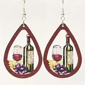 Detail view of teardrop wooden earrings featuring wine bottle and grape illustration
