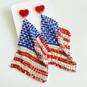 Detailed close-up of heart-shaped USA flag earrings with metallic mesh and red sequins