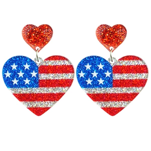 Close-up of glitter heart earrings with US flag star and stripes festive pattern
